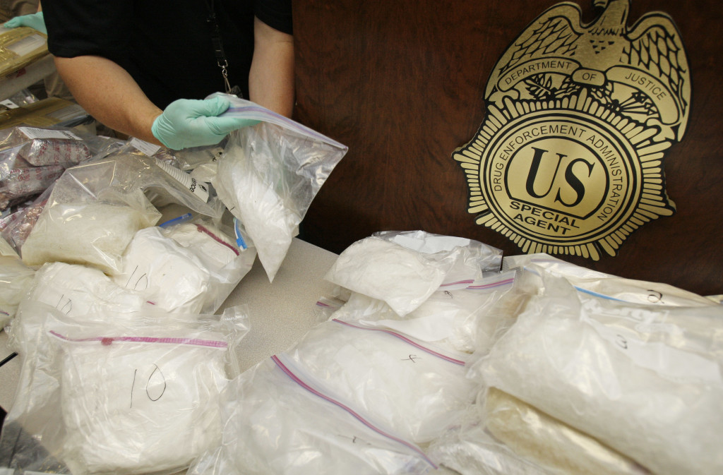 A police officer packs up bags of methamphetamine after a news conference in Atlanta to announce the seizure of an estimated $6 million worth of the drug on Wednesday, May 13, 2009. (AP Photo/John Bazemore)