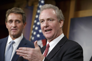 Sen. Jeff Flake, R-Ariz. listens at left as Rep. Chris Van Hollen, D-Md., speaks during a news conference on Capitol Hill in Washington, Wednesday, Dec. 17, 2014, after traveling with Sen. Patrick Leahy, D-Vt., to Havana earlier today to bring back American prisoner Alan Gross who has been held by the Cuban government. President Barack Obama announced that the United States and Cuba have agreed to re-establish diplomatic relations and open economic and travel ties, marking a historic shift in U.S. policy toward the communist island after a half-century of enmity dating back to the Cold War. (AP Photo/J. Scott Applewhite)