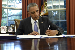 President Barack Obama signs the FOIA Improvement Act of 2016 in the Oval Office of the White House in Washington, Thursday, June 30, 2016. Obama also signed the Puerto Rico Oversight, Management, and Economic Stability Act. (AP Photo/Susan Walsh)