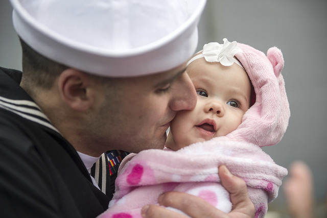 NORFOLK (Dec. 24, 2016) A Sailor greets his daughter after returning home aboard the amphibious assault ship USS Wasp (LHD 1) as part of the Wasp Amphibious Ready Group (WSP ARG) homecoming from a six-month deployment in support of maritime security operations and theater security cooperation efforts in Europe and Middle East. WSP ARG includes Commander, Amphibious Squadron 6; USS Wasp (LHD 1); USS San Antonio (LPD 17); USS Whidbey Island (LSD 41) and 22nd Marine Expeditionary Unity (MEU). #Home4TheHolidays (U.S. Navy photo by Mass Communication Specialist 2nd Class Andrew Schneider/Released)